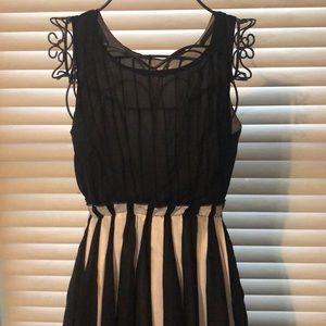 Beautiful black dress with white pleaded accents.